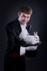 man dressed as a magician pulling a rabbit from his hat