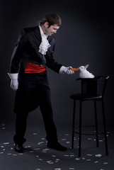 man dressed as a magician pulling a rabbit from his hat
