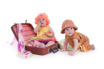 portrait of two kids with a large suitcase