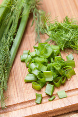 dill and parsley on chopping board