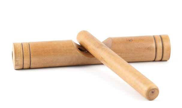 Wooden claves isolated on a white background.