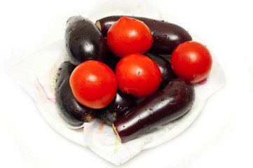 Fresh tomatoes and eggpalnts on white