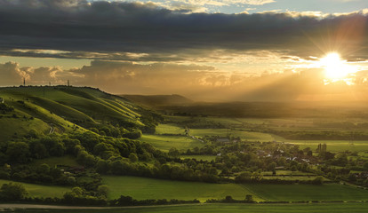 Stunning Summer sunset over countryside landscape