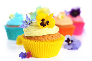 cupcakes with cream and decorated with violets