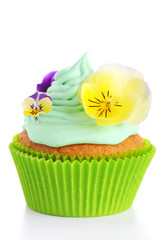 Easter cupcakes on white background decorated with fresh violets