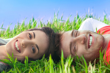 Happy couple lying in the grass