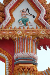 Stucco art on arch doorway of buddhist temple