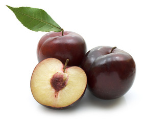 plums with leaf on white background