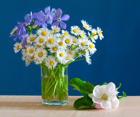 A bouquet of spring flowers in a glass