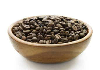 Coffee beans in wooden bowl isolated on white