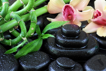 Spa still life with hot stones and orchid