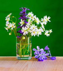 A bouquet of spring flowers in a glass