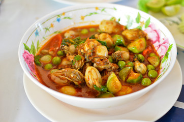 Spicy oyster soup with variety of herbs