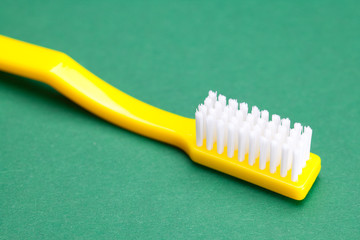 yellow toothbrush on a green background