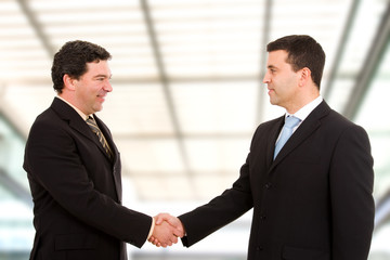 Business people shaking hands, finishing up a meeting at modern