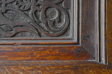 Fragment of woodcarving in antique wooden cupboard