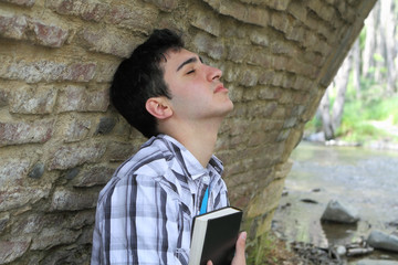 Man Holding Bible Close to Chest