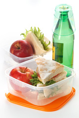 Lunch box with sandwich apple and milk