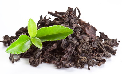 Heap of dry tea with green tea leaves.