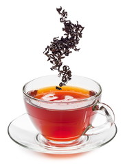 Cup of tea and dry tea leaves.