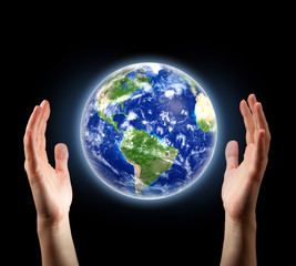 hands surrounding planet Earth