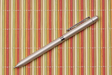 pen on colorful bamboo mate