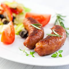 Grilled sausage with herbs and salad