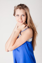 portrait of a beautiful young woman in blue dress