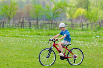 Fototapeta premium Boy with hat riding a bicycle