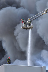 Firefighters fighting a fire at a warehouse