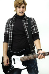 Young man posing with electric bass