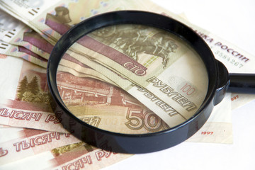 Magnifying glass on money