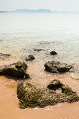 Seaside island with sand and rocks on the shore