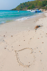 Heart drawn on a white sand beach on the paradise island