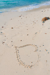 Heart drawn on a white sand beach on the paradise island