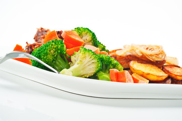 Fried potatoes broccoli carrots and roasted chicken