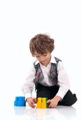 Cute little boy playing with toy construction set