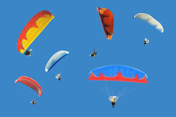 Colorful paramotor on blue sky