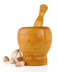 garlic in mortar and pestle isolated on white