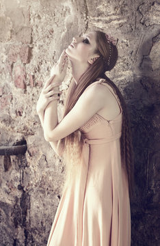 young blond woman posing on wall background