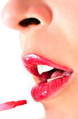 Obraz premium Close up of a girl with opened mouth, putting makeup on