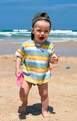 Fototapeta na wymiar Happy boy on beach