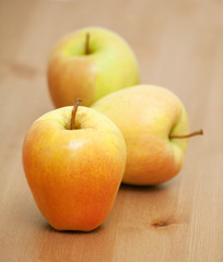 three apples on a table