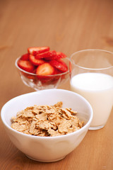 breakfast cereal, milk and strawberries