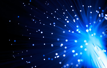Defocused fiber optics in blue tones on black background