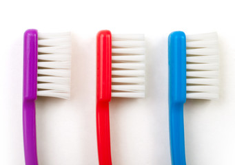 three toothbrushes white background