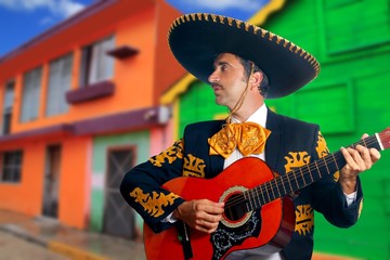Charro Mariachi playing guitar Mexico houses