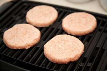 Raw Turkey Burgers on Grill