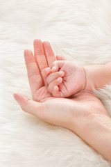 Baby's hand on mother's palm