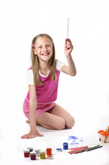 Happy little girl with brush on white background